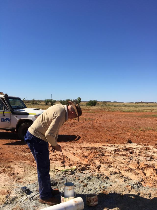 Bob Paul measuring depth to groundwater and water salinity at a recently constructed pastoral bore on Karratha Station.