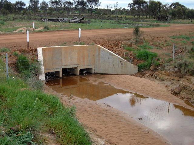 Photograph of a road culvert filled with sediment