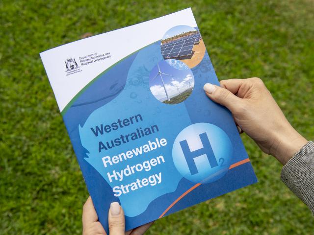 Hands holding the Western Australian Renewable Hydrogen Strategy document